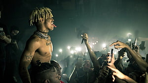 XXXTentacion performing shirtless at a live concert with crowd and stage lights HD wallpaper