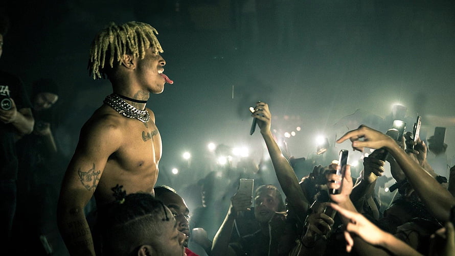 XXXTentacion performing shirtless at a live concert with crowd and stage lights HD wallpaper