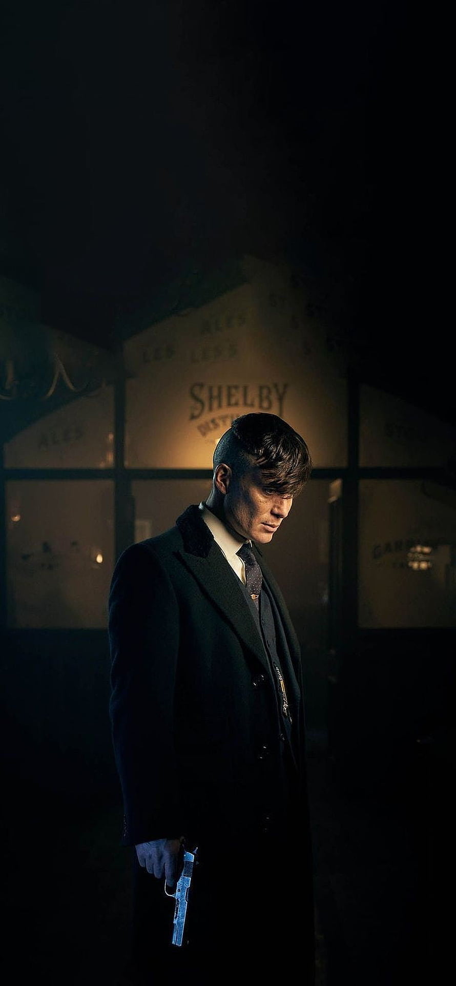 Peaky Blinders Tommy Shelby holding a pistol in a dark alley with brewery signage HD phone wallpaper