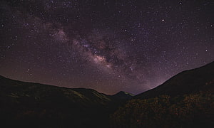 Milky Way Galaxy Arching Over Dark Mountain Ridges and Starry Night Sky HD wallpaper