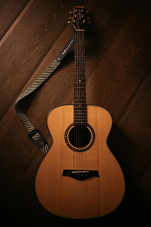 Acoustic Guitar with Striped Strap on Dark Wood Floor HD phone wallpaper