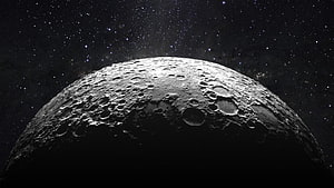 Cratered Moon Surface Rising Against a Star-Filled Deep Space Sky HD wallpaper
