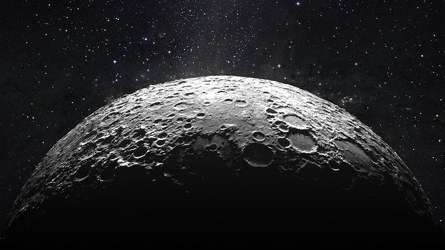 Cratered Moon Surface Rising Against a Star-Filled Deep Space Sky HD wallpaper