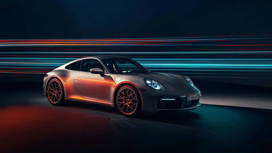 Silver Porsche 911 Sport Coupe with Neon Light Trails on Dark Background HD wallpaper