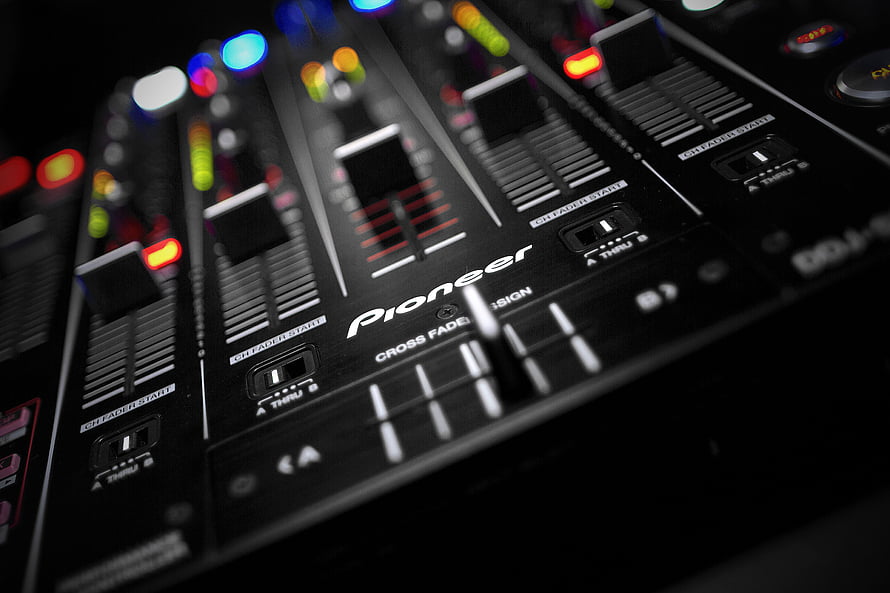 Pioneer DJ Mixer Close-Up with Illuminated Faders and Crossfader Controls HD wallpaper