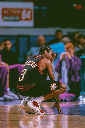 Allen Iverson Crouching on the Court in a Black Jersey with Red Trim HD phone wallpaper