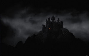 Gothic Castle Silhouette on a Dark Mountain Peak Under Stormy Night Sky HD wallpaper