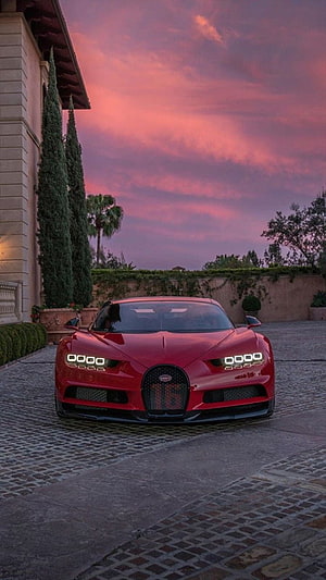 Red Bugatti Chiron Parked on Cobblestone Driveway at Sunset HD phone wallpaper