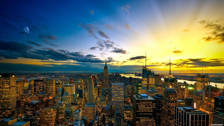 New York City Skyline at Golden Hour with Moon and Dramatic Clouds HD wallpaper