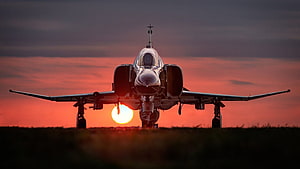 Military Fighter Jet Silhouette Against Vibrant Sunset Sky HD wallpaper