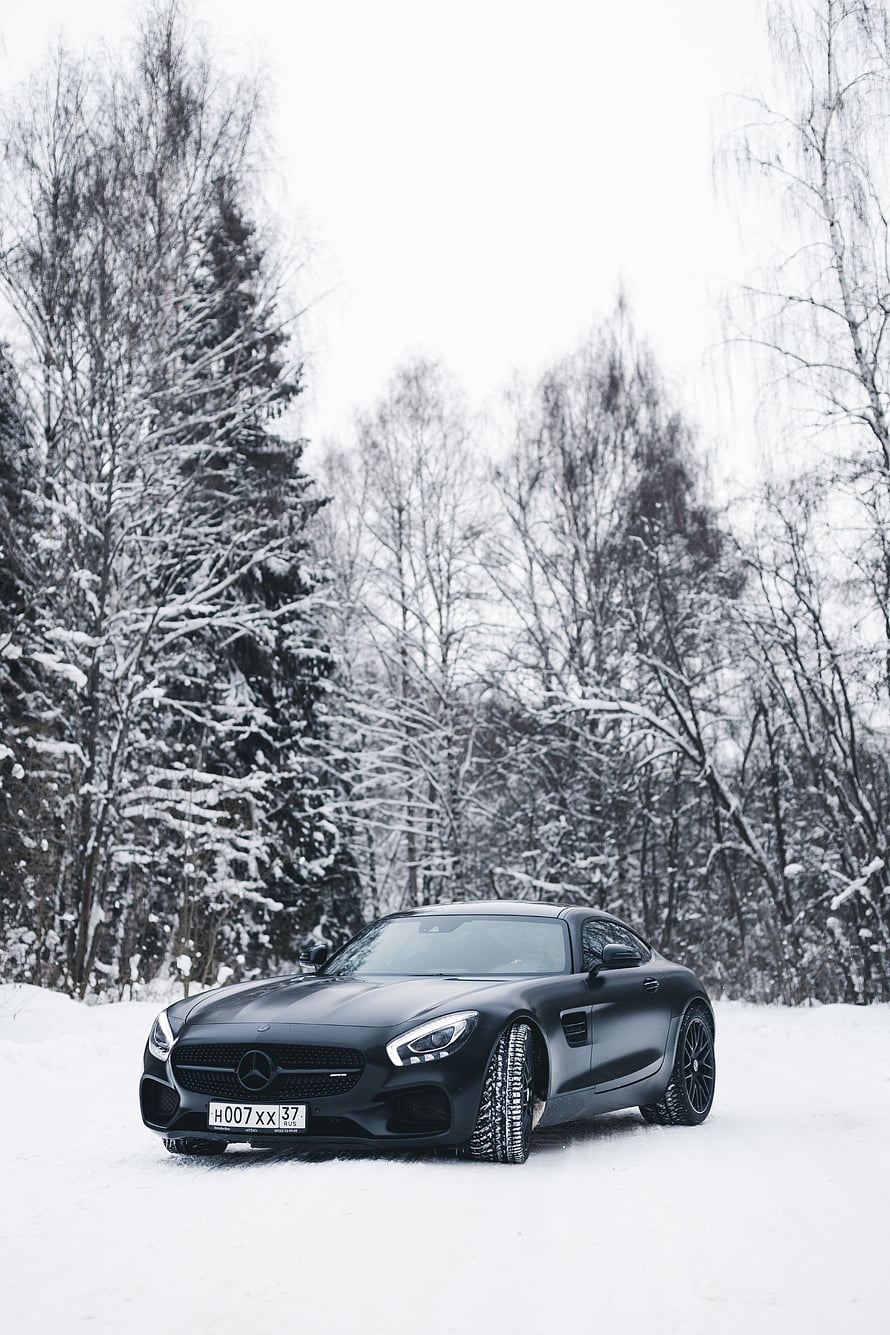 Matte Black Mercedes-AMG GT Coupe Parked on a Snowy Forest Road in Winter HD phone wallpaper