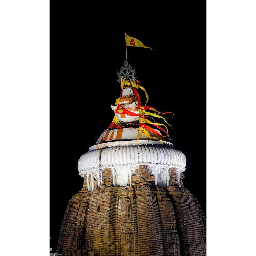 Jagannath Temple Spire at Night with Colorful Prayer Flags and Ornate Carvings HD phone wallpaper