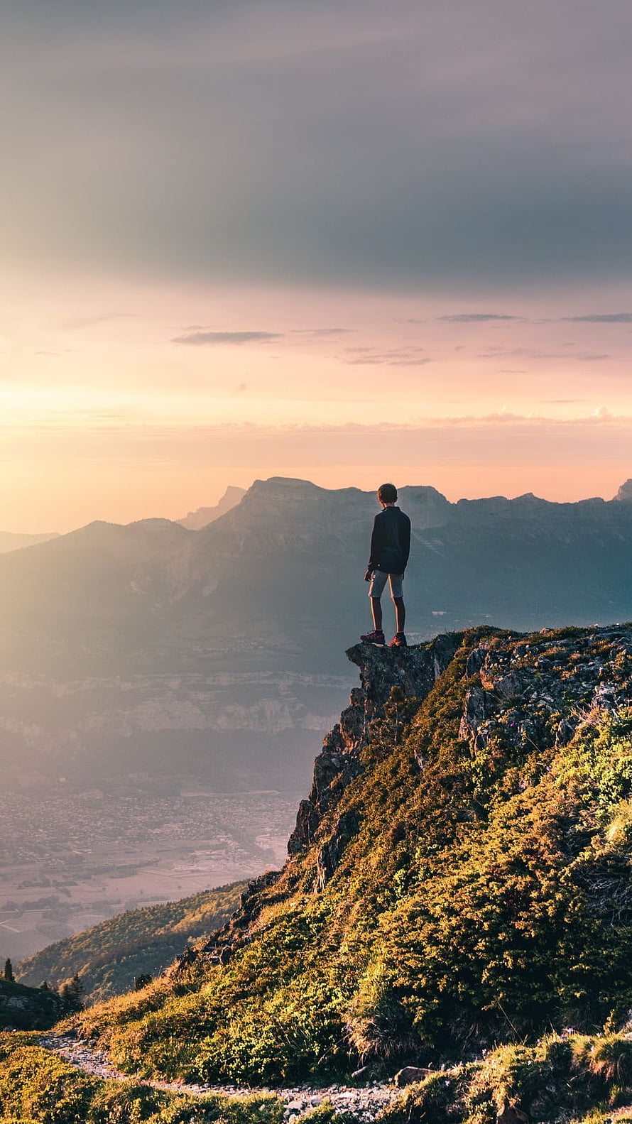 Lone Hiker Standing on Rocky Mountain Ridge at Golden Hour Sunset HD phone wallpaper