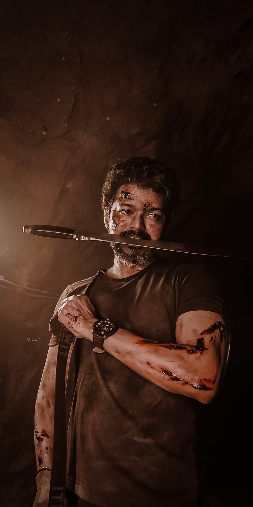 Thalapathy Vijay in Beast Veera holding a knife with blood-stained arms in a dark gritty scene HD phone wallpaper