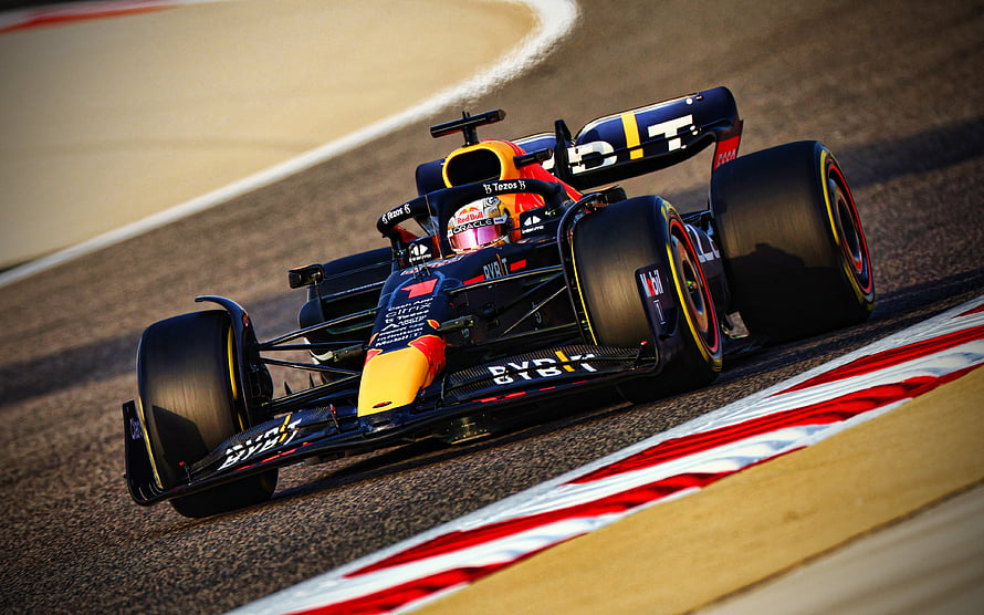 Max Verstappen in the Oracle Red Bull Racing RB18 cornering on a Formula 1 circuit HD wallpaper