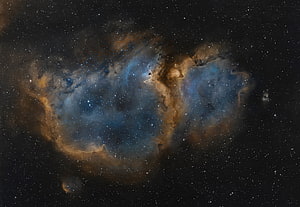 Vibrant Blue and Gold Nebula Clouds Against a Star-Filled Deep Space Background HD wallpaper