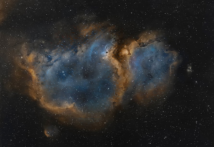Vibrant Blue and Gold Nebula Clouds Against a Star-Filled Deep Space Background HD wallpaper