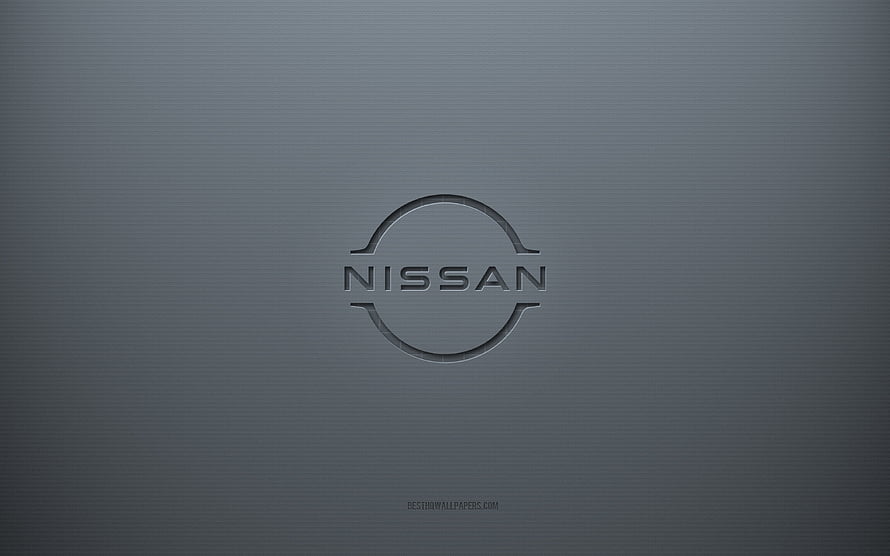 Nissan emblem embossed on a smooth gray metallic surface with a minimalist 3D design HD wallpaper