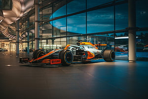 McLaren Formula 1 car with Gulf livery displayed inside the McLaren Technology Centre HD wallpaper