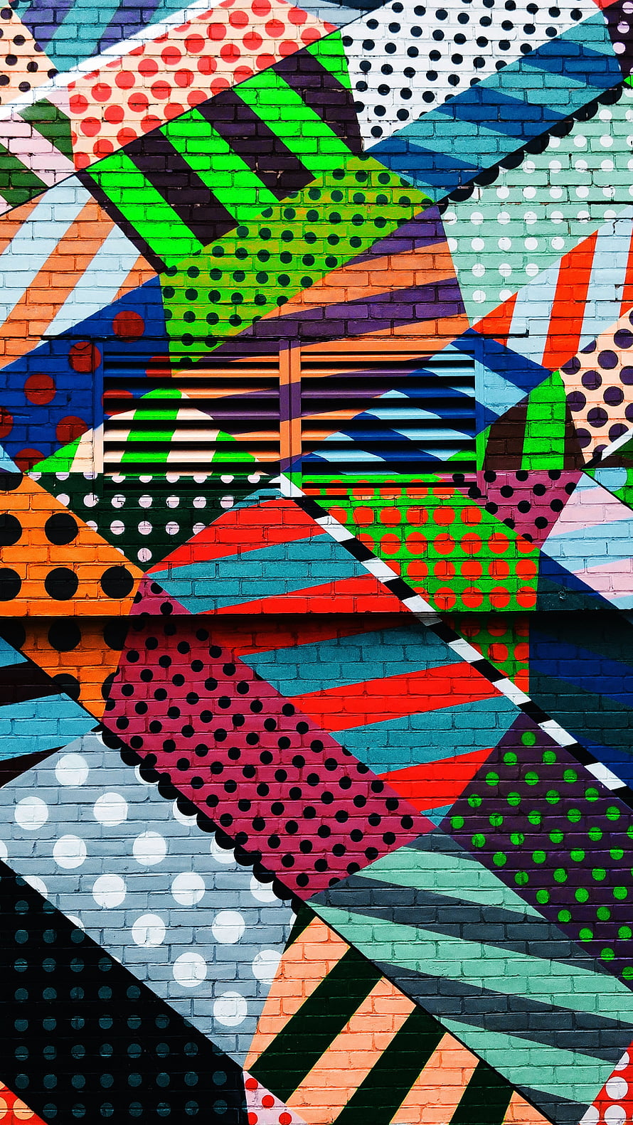 Vibrant Geometric Street Art Mural on Brick Wall with Polka Dots and Bold Shapes HD phone wallpaper