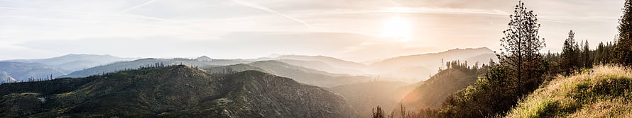 Panoramic Mountain Range at Sunrise with Golden Light and Misty Valleys HD wallpaper