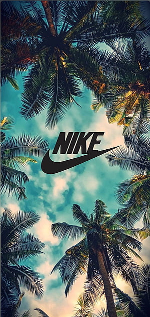 Nike Logo Centered Against Tropical Palm Trees and Blue Sky HD phone wallpaper