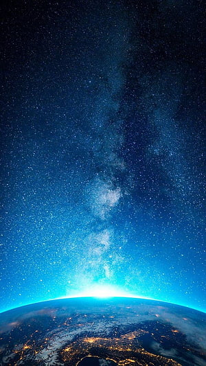 Milky Way Galaxy Rising Over Earth's Horizon With City Lights Below HD phone wallpaper