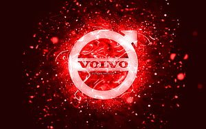 Volvo emblem glowing with red neon energy and abstract particle effects on a dark background HD wallpaper