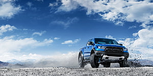 Blue Ford Ranger Raptor Off-Road Pickup Truck Driving on Gravel Terrain Under Blue Sky HD wallpaper