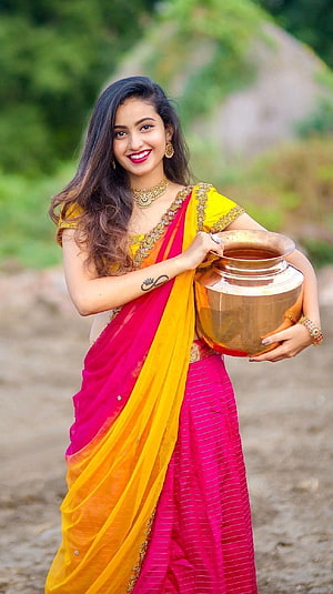 Deepika Pilli in Vibrant Pink and Yellow Saree Holding Traditional Copper Pot HD phone wallpaper
