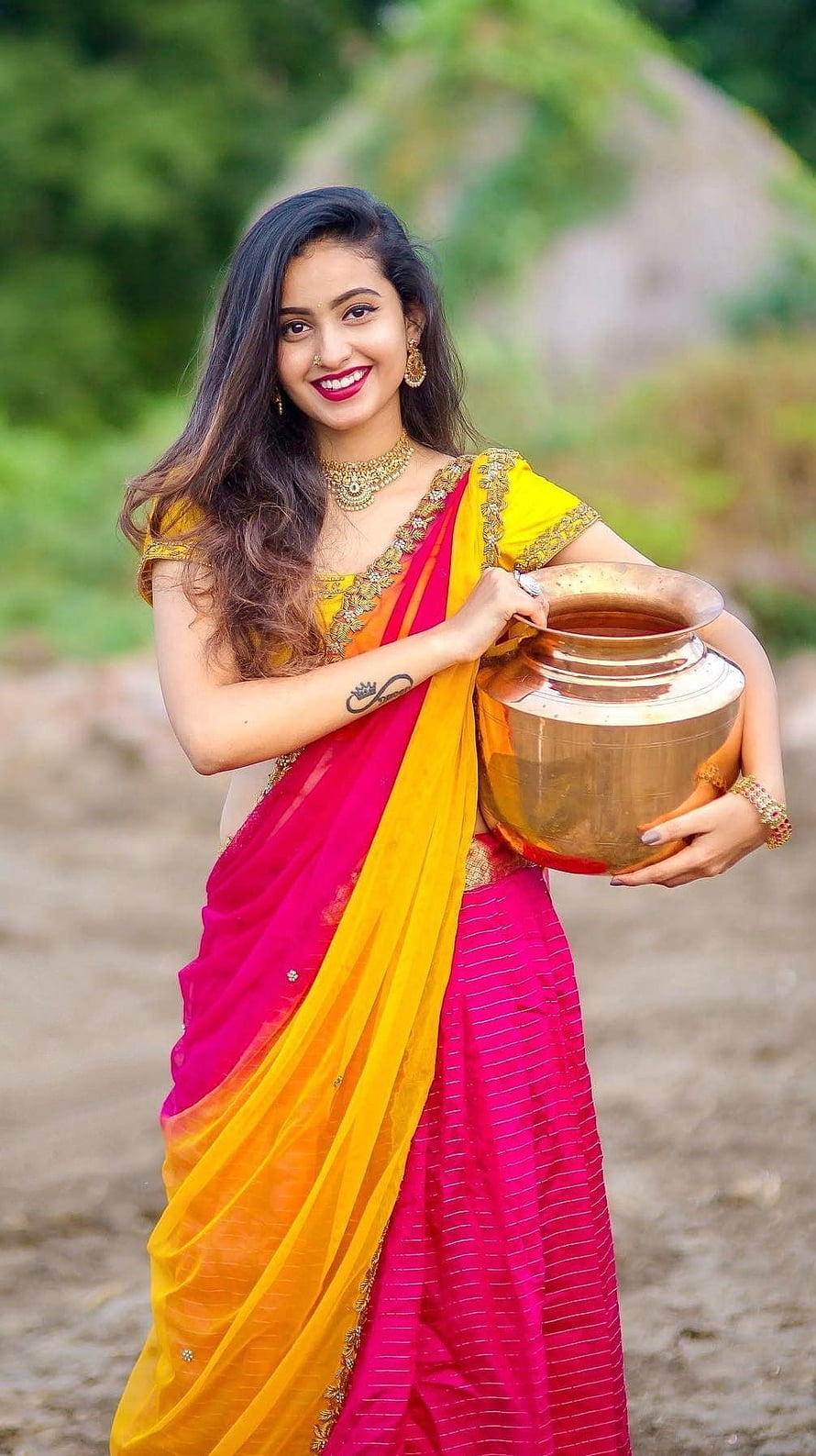 Deepika Pilli in Vibrant Pink and Yellow Saree Holding Traditional Copper Pot HD phone wallpaper