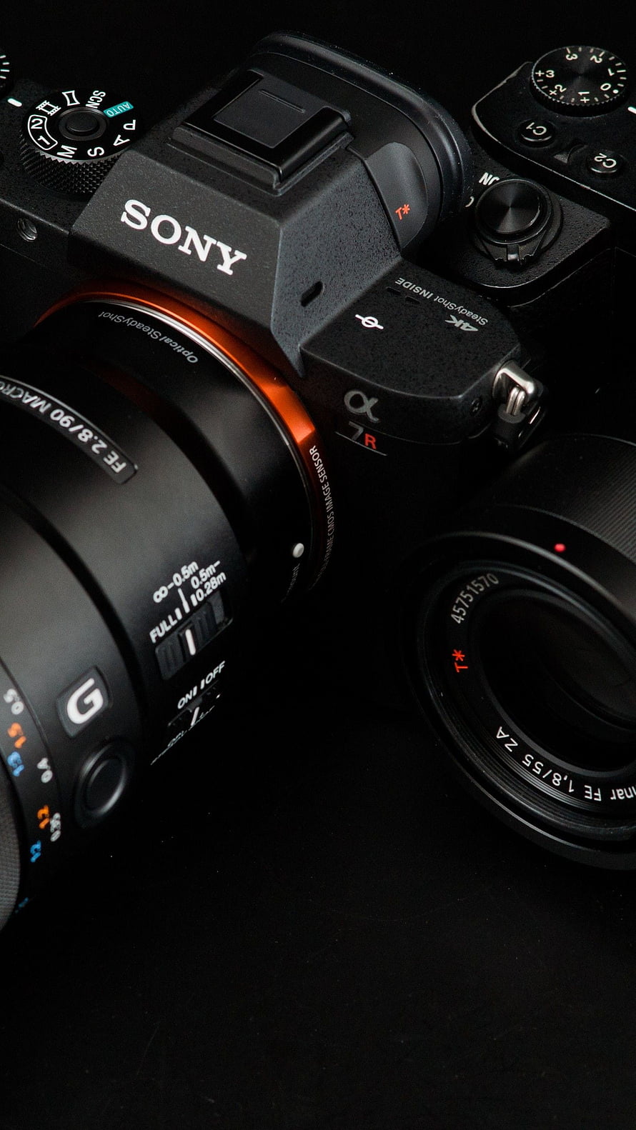 Sony Alpha 7R Mirrorless Camera with G Master Lens on Black Background HD phone wallpaper