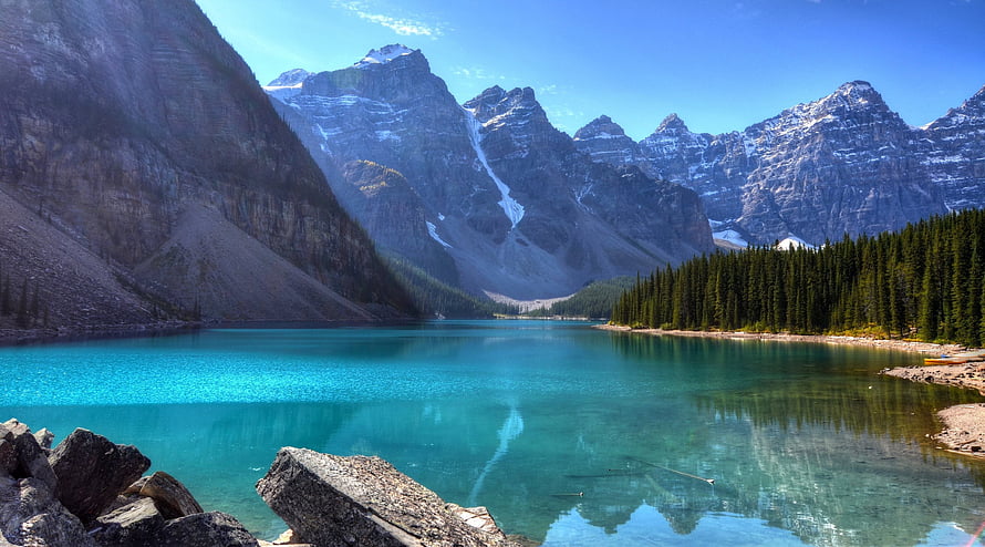 Turquoise Mountain Lake Surrounded by Pine Forest and Snow-Capped Peaks HD wallpaper