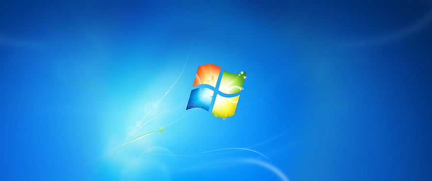 Windows 7 Default Desktop Background with Vibrant Blue Gradient and Glowing Logo HD wallpaper