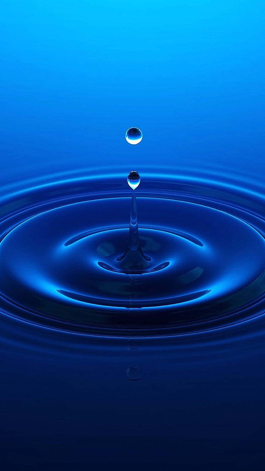 Vibrant Blue Water Droplet Splash with Expanding Ripples on a Smooth Surface HD phone wallpaper