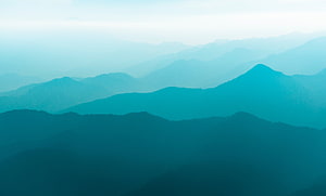 Layered Mountain Ranges in Misty Teal and Cyan Tones HD wallpaper