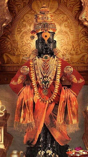 Ornate Vitthal Deity Statue Adorned in Red Garments and Gold Jewelry HD phone wallpaper