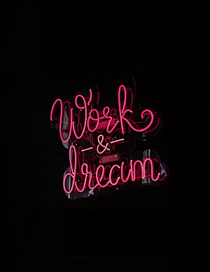 Glowing Pink Neon Sign Reading Work and Dream on a Dark Black Background HD phone wallpaper