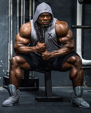 Kai Greene Bodybuilder Portrait in Gym Hoodie and Tank Top HD phone wallpaper