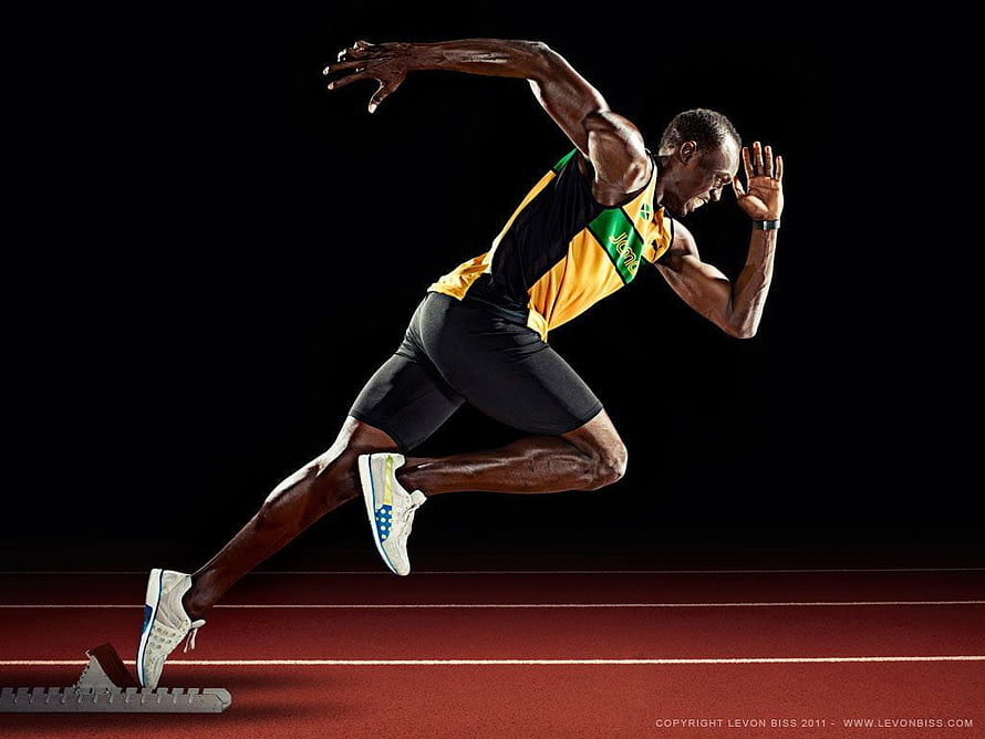 Usain Bolt Sprinting Out of Starting Blocks on Track HD wallpaper