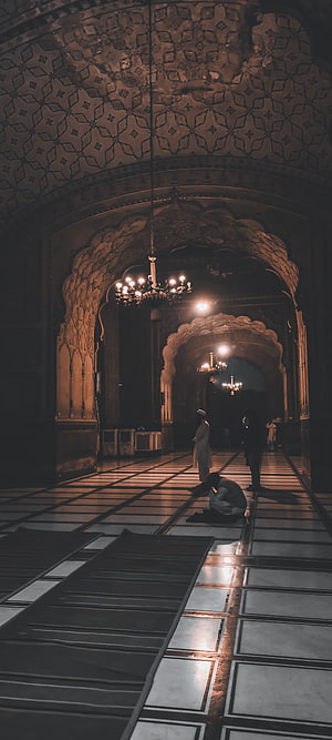 Badshahi Mosque Interior with Praying Figures and Ornate Arches HD phone wallpaper