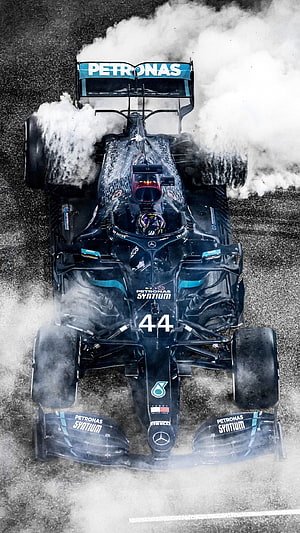 Mercedes AMG Petronas Formula 1 Car Number 44 Drifting Through Water Spray on Wet Track HD phone wallpaper