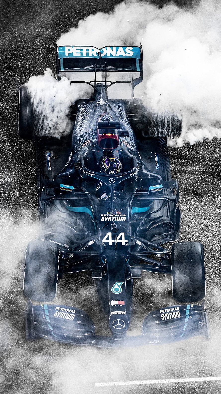 Mercedes AMG Petronas Formula 1 Car Number 44 Drifting Through Water Spray on Wet Track HD phone wallpaper