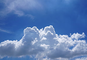Fluffy Cumulus Clouds Floating in a Bright Blue Summer Sky HD wallpaper
