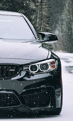 Black BMW M3 F80 Front Headlight Close-Up in Snowfall HD phone wallpaper