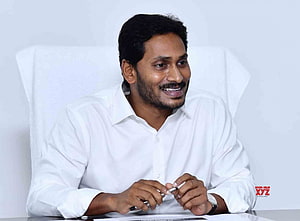 Y. S. Jagan Mohan Reddy in white shirt seated at a desk during an official meeting HD wallpaper