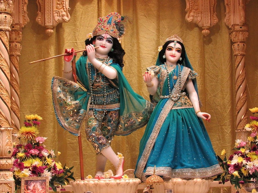 Radha Krishna Temple Deities in Ornate Green Attire with Floral Arrangements HD wallpaper