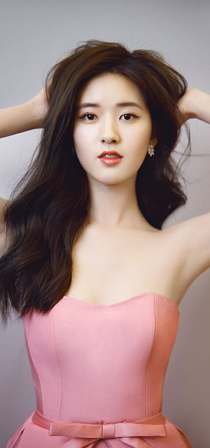 Zhao Lusi in a soft pink strapless gown with a satin bow belt and flowing dark hair HD phone wallpaper