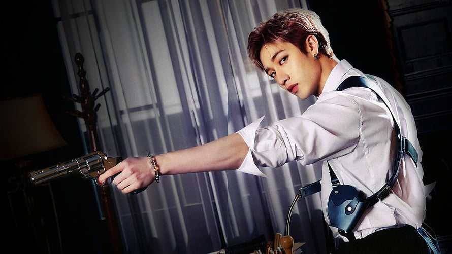 Bang Chan from Stray Kids in a dramatic white shirt and gun holster pose HD wallpaper
