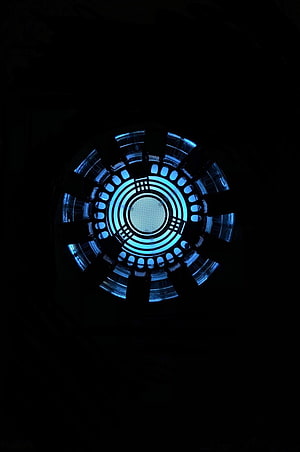 Glowing Arc Reactor Core with Blue Illumination on Black Background HD phone wallpaper